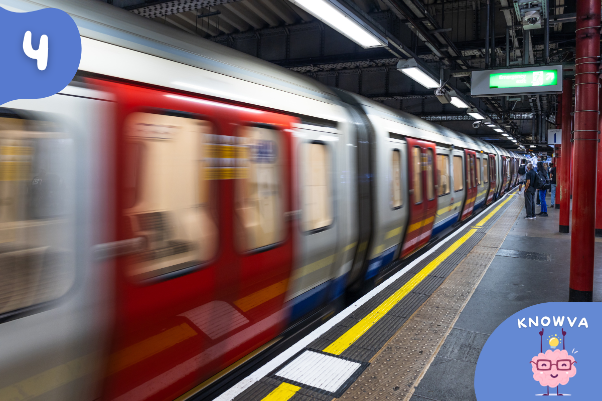 A London Underground train arriving at a platform inside an underground station.