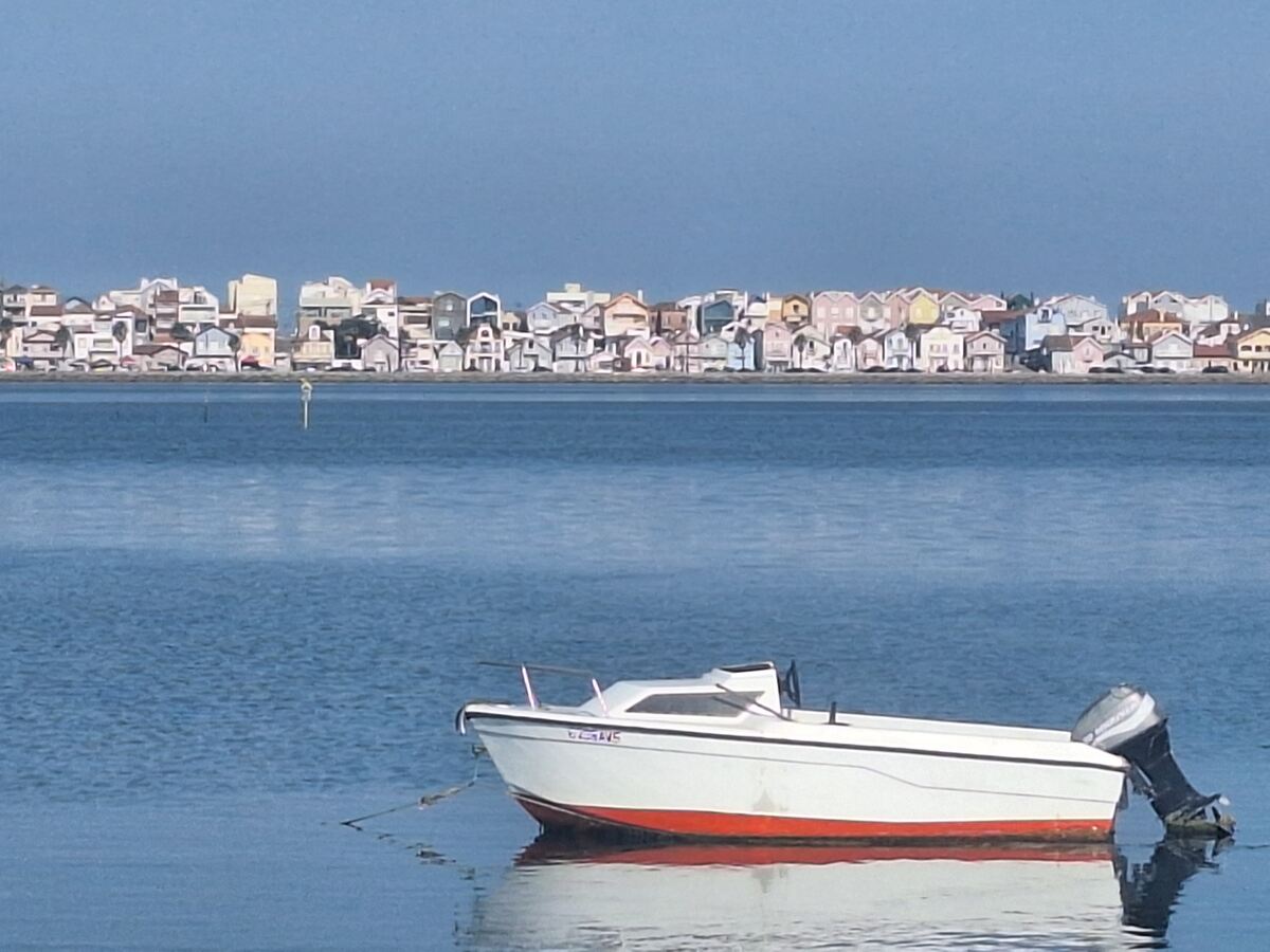 This photo from July 2026 shows Costa Nova (Aveiro district), as seen across the lagoon from the bike path around the Ria de Aveiro.