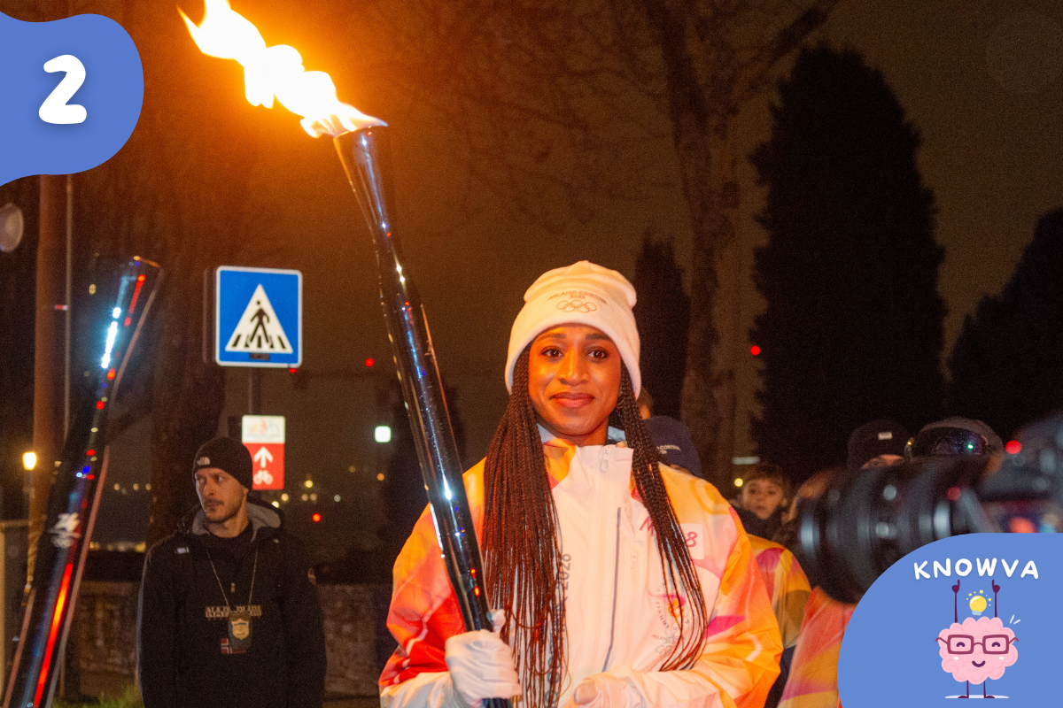 Olympic torch burning at night during a relay event