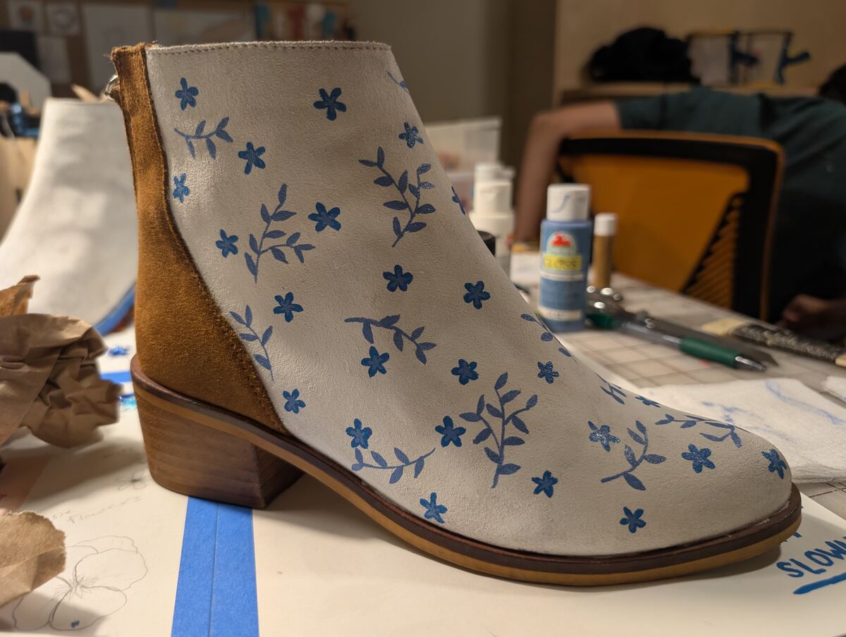 A picture of one of the boots with blue flowers and slightly lighter blue leaves