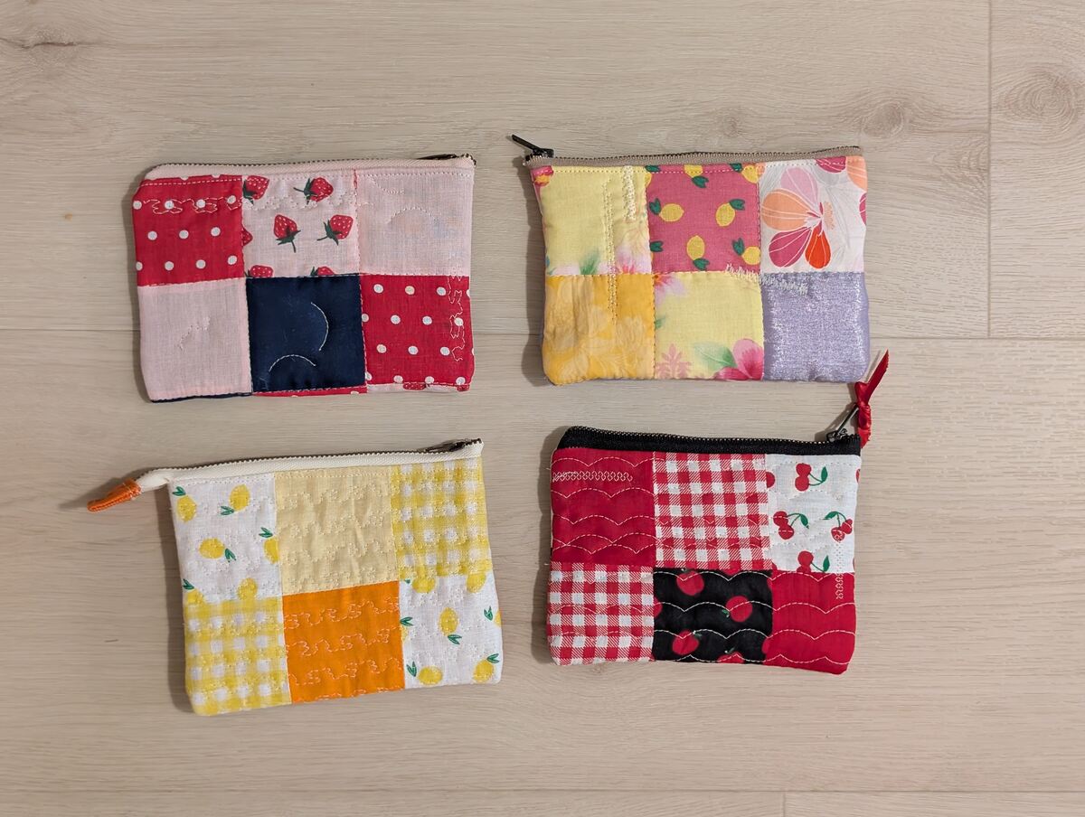 A photo of four quilted zipper pouches.