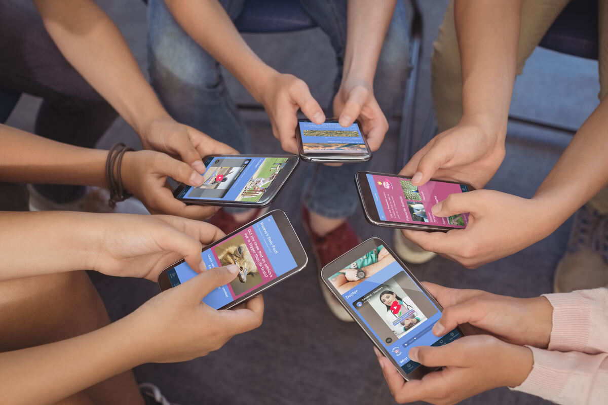 A group of five children using different Knowva features, including Knowva's Daily Fact, on their mobile devices.